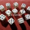 Bone dice with X black dot